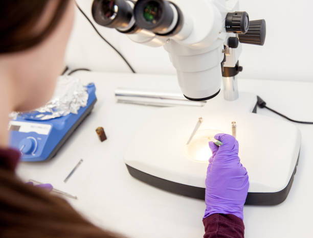 istock Woman Scientist Researching Material Sample With Microscope 971090006
