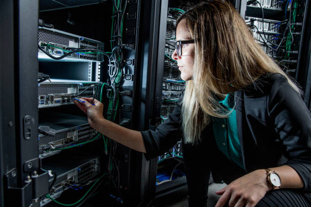 female it engineer working in server room - computer network server repairing technology imagens e fotografias de stock
