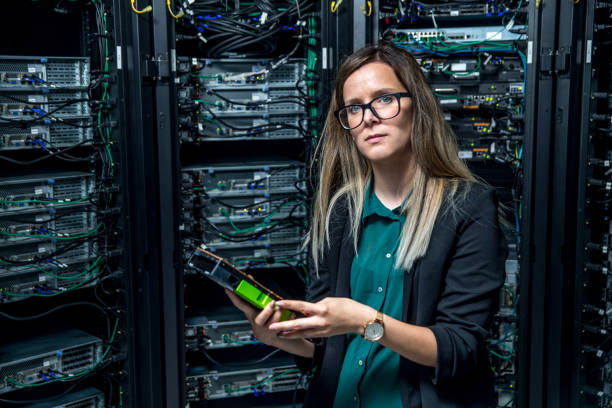 istock Female IT Engineer Holding Computer Part in Hands in Server Room 971101348