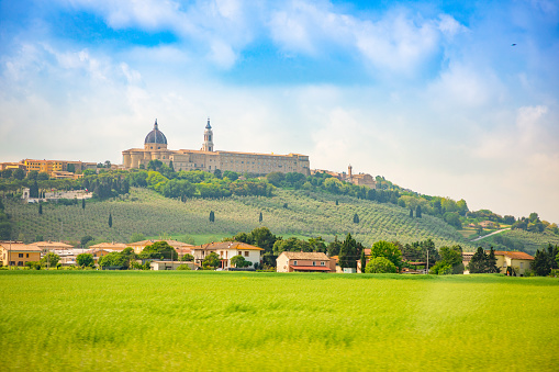 Loreto, Basilica over summer fields in Italian province of Ancona, Italy