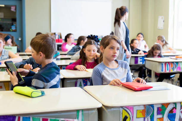 istock Multi-ethnic students sit into the class for the first day at school 971120814