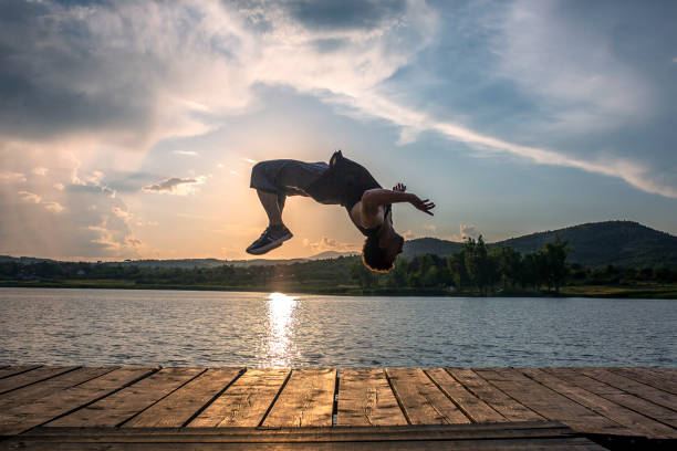 istock Young man acrobat trains on a pier 971133304