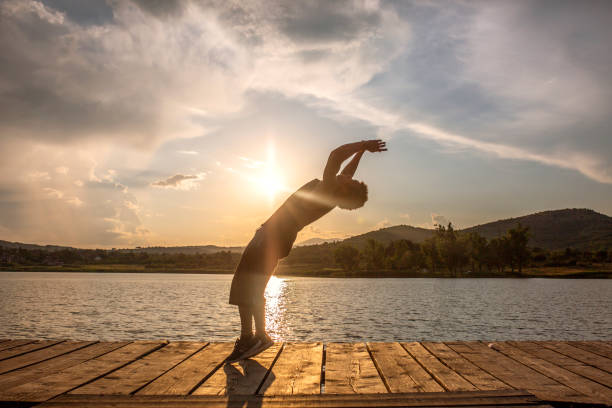 istock Young man acrobat trains on a pier 971133308