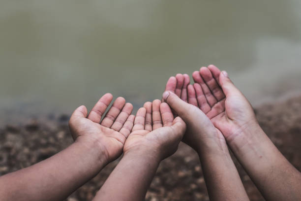 istock Cropped Hands Gesturing Against Lake 971162320