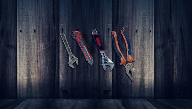 istock Close-Up Hands Tools Hanging On Wooden Wall 971165520