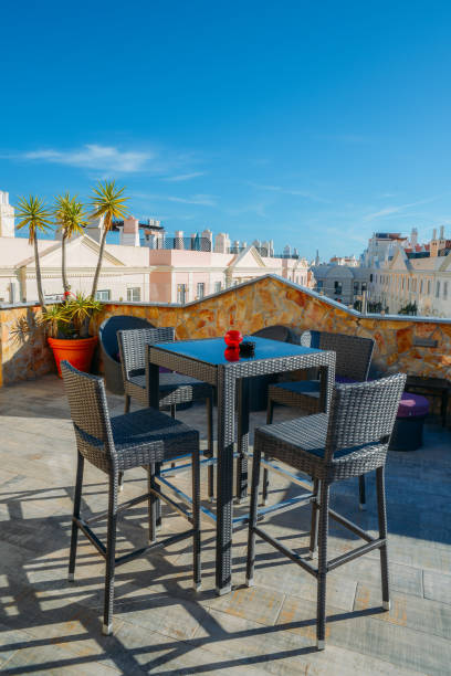 istock Table and chairs at a patio on a rooftop bar with sunny copy space background 971166316