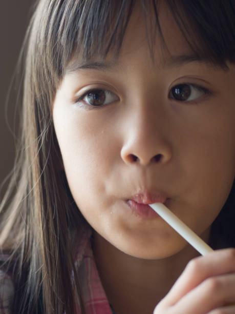 istock A eurasian girl drinks from a straw. 971181660
