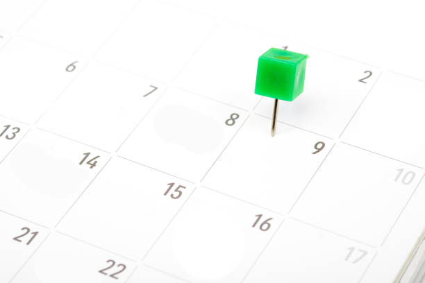 istock Close up green pin on White Calendar. 971183638