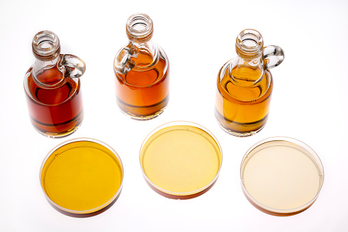 sampler of pure maple syrup (golden, amber and gold) - three small glass bottles and small bowls on white