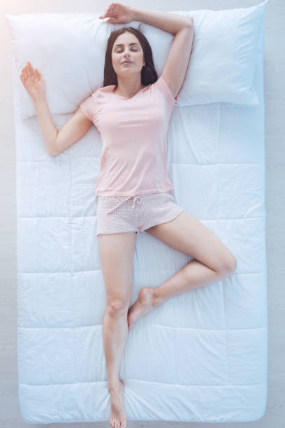 istock Tired brunette enjoying sleep in bed 971190274
