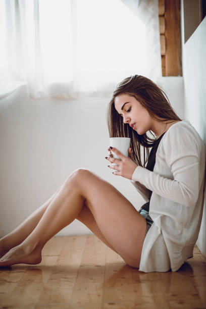 istock Cute Female Drinking First Morning Coffee After Waking Up 971207070