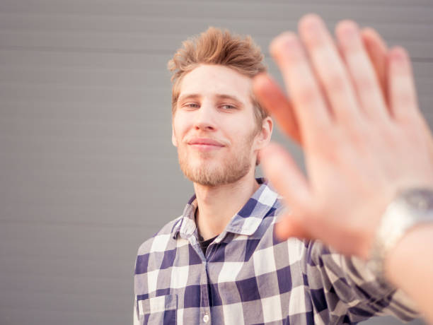 istock first person view of guys high five isolated with copy space 971209470