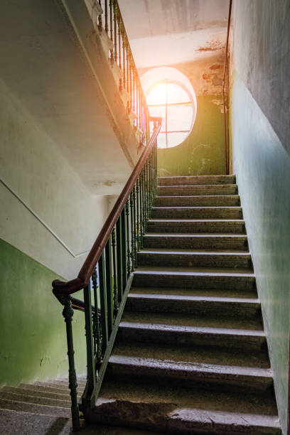 istock Old vintage staircase at the old house. Oval window 971210632