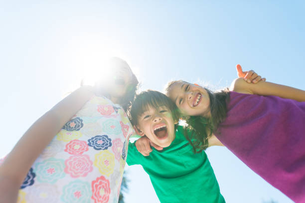 istock Three elementary-age kids posing on a hot summer day 971216002