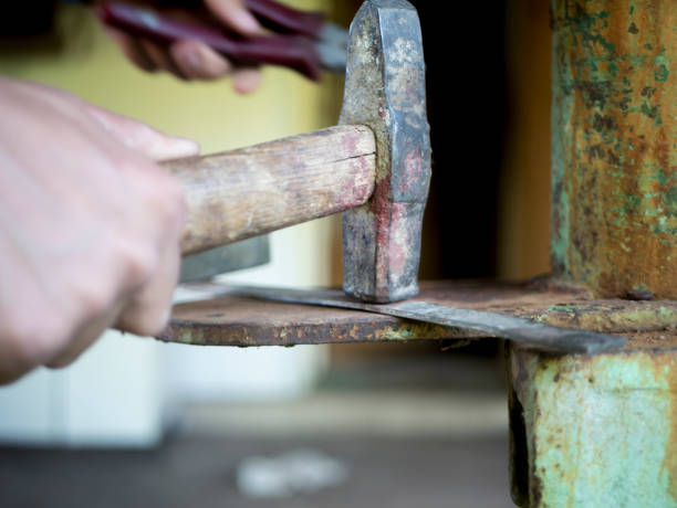 istock close up hand with hammer working in workshop 971218848