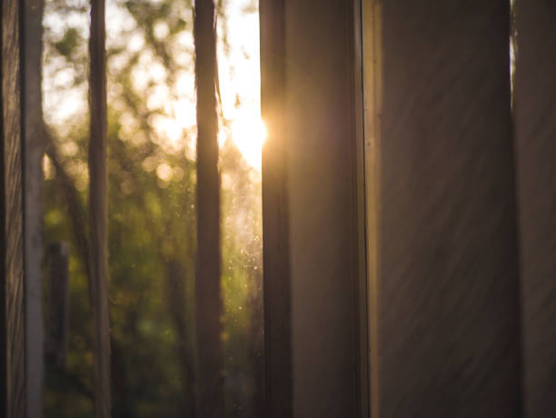 istock close up looking at sunset through the window at home 971218926