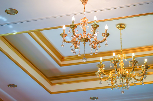 Simple and minimize chandelier gold colour on the ceiling