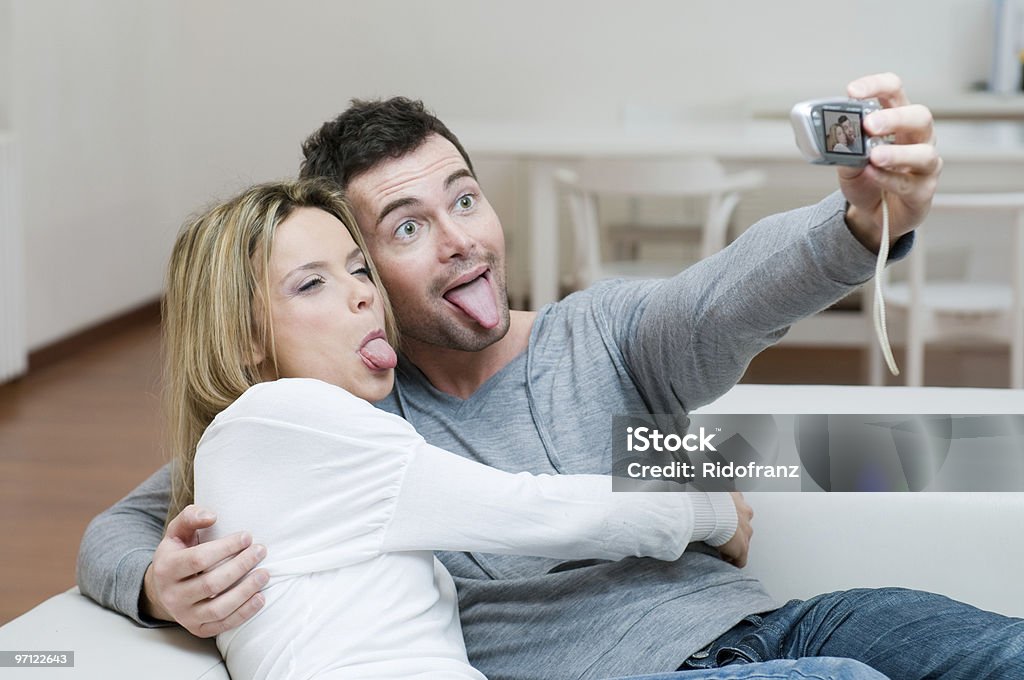 Young couple making faces and photo Young couple making a funny face while taking a self portrait. Adult Stock Photo