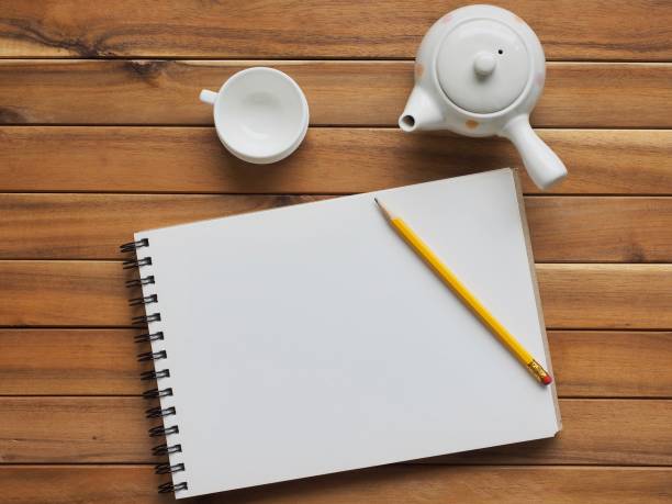Sketch book, porcelain kettle, pencil, stock photo