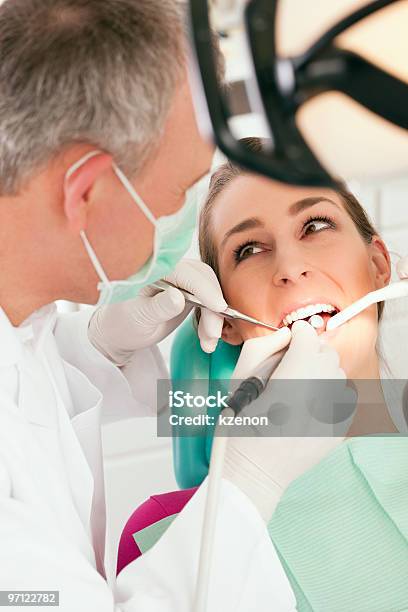 A Dentist Working On A Patients Teeth Stock Photo - Download Image Now - Adult, Color Image, Dental Drill