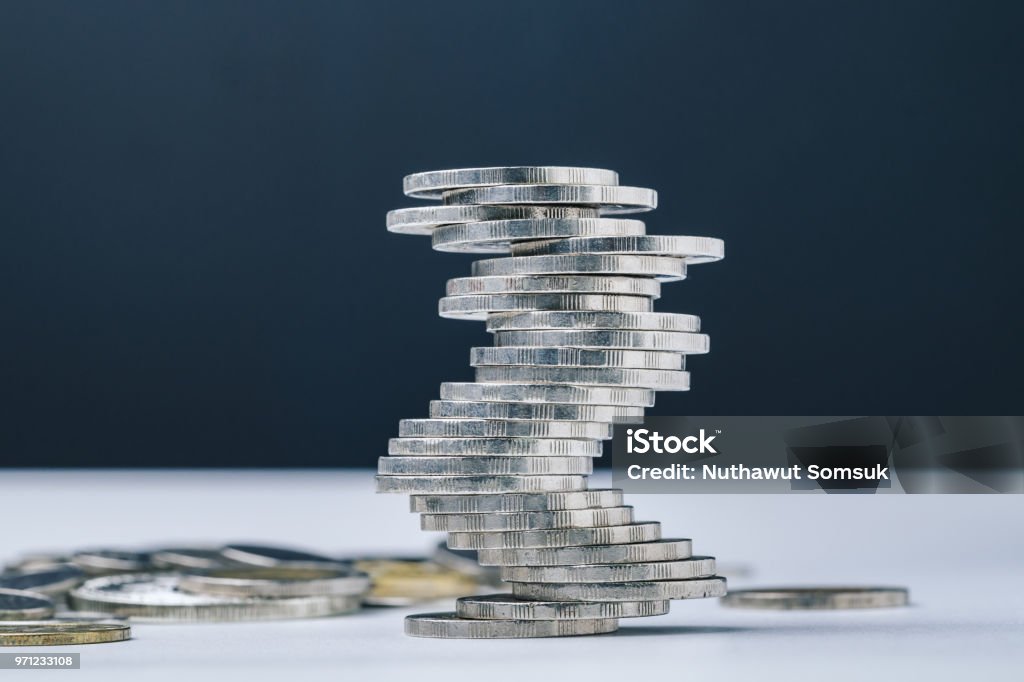 Unstable closed to collapse stack of coins tower , uncertainty of business, risk of financial or investment, no stability, problem or crisis concept Unstable closed to collapse stack of coins tower , uncertainty of business, risk of financial or investment, no stability, problem or crisis concept. Stability Stock Photo