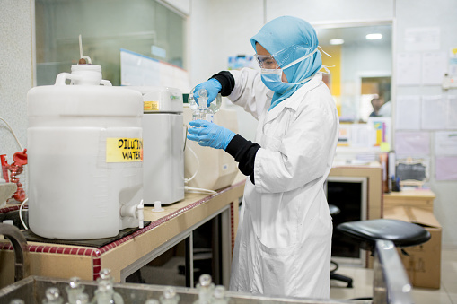 Young woman wearing a hijab working in a research laboratory. Kuala Lumpur, Malaysia