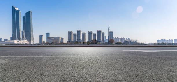 istock Panoramic skyline and modern business office buildings with empty road,empty concrete square floor 971241038