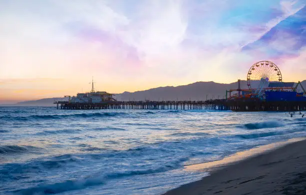 a view of Santa Monica beach and pier at sunset