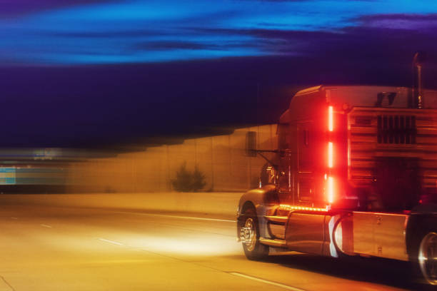 istock Truck on the road at night 971243630