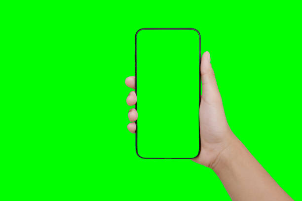 istock hand holding mobile phone isolate on green background 971268294