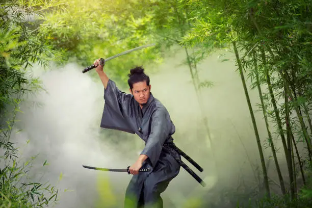 Japanese man in a samurai holding a katana sword