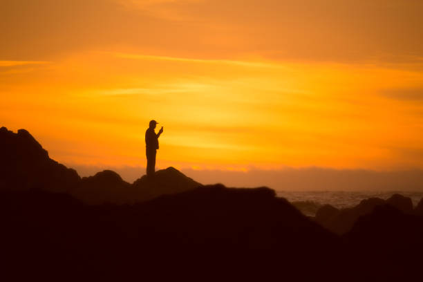 istock Silhouetted man checks his cell 971275900