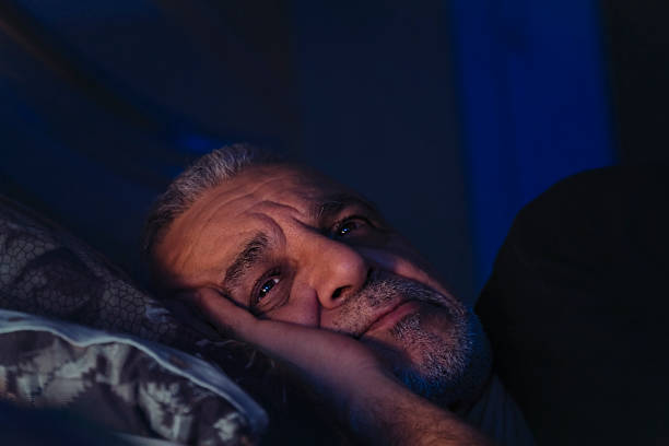 Elderly man lost in thought stock photo