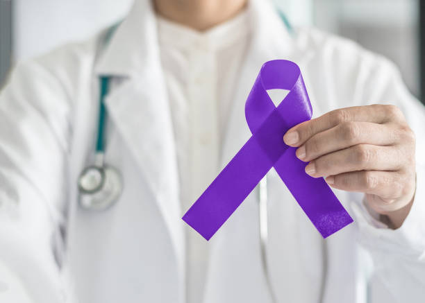 couleur de proue symbolique de ruban violet violet sur support main du médecin pour le lymphome hodgkinien et la sensibilisation du cancer du testicule - hodgkins disease photos et images de collection