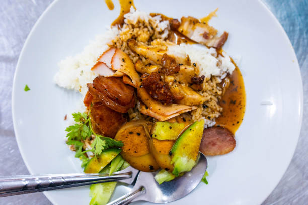istock Barbecued red pork in sauce and crispy pork with rice 971283536
