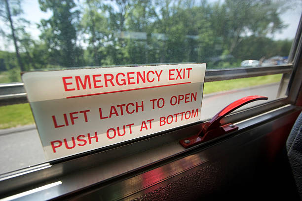 Emergency Exit An Emergency Exit sign on a school bus window. window latch stock pictures, royalty-free photos & images