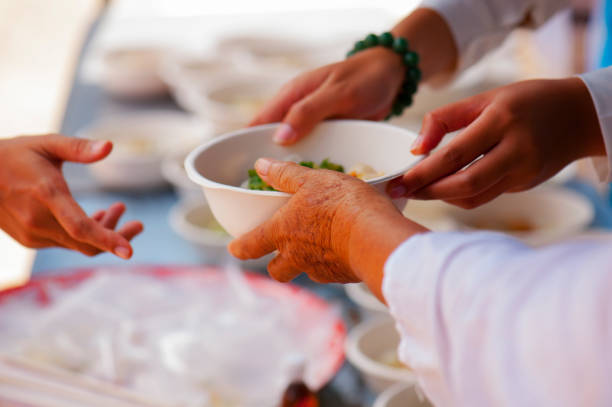 istock Help with feeding homeless people to alleviate hunger. poverty concept 971286490