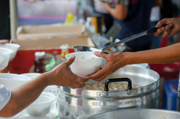 istock Help with feeding homeless people to alleviate hunger. poverty concept 971286498