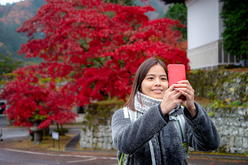 An asian girl was sightseeing Nikko in Autumn