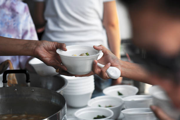 istock Help with feeding homeless people to alleviate hunger. poverty concept 971286816