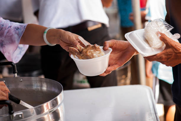 istock Feeding the poor to alleviate hunger. give concept 971290044