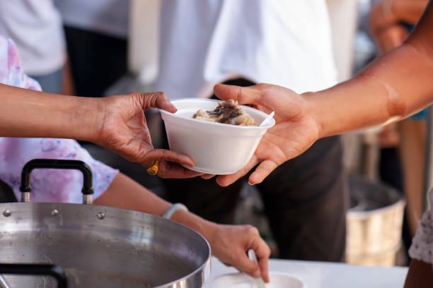 istock Feeding the poor to alleviate hunger. give concept 971292118