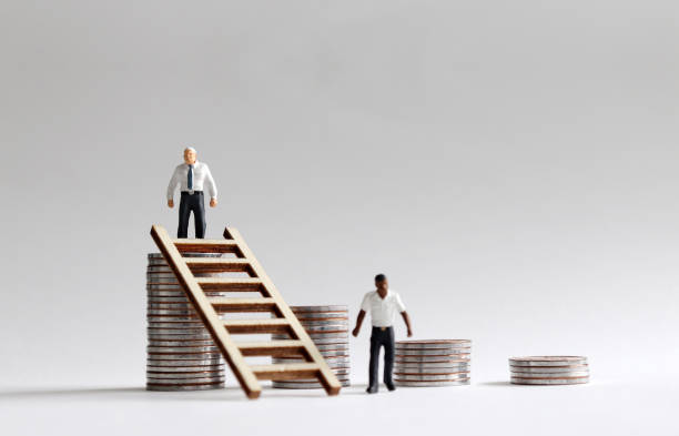 istock Social income difference and racial discrimination problem. Miniature people with different races and coins. 971292250