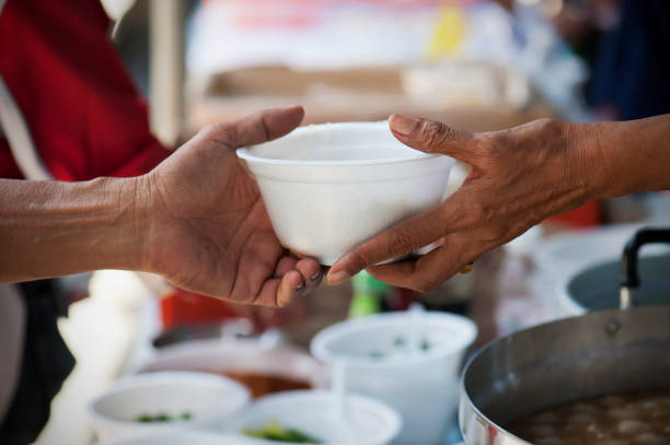 istock Feeding the poor to alleviate hunger. give concept 971292736