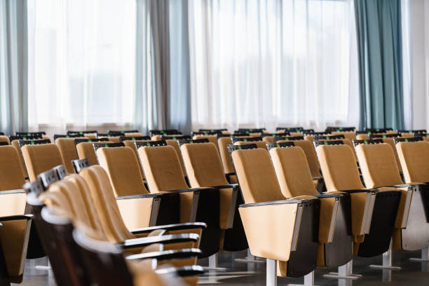 istock Seminar presentation. Empty conference room, lots of empty seats. Auditorium for workshops and seminars 971304724