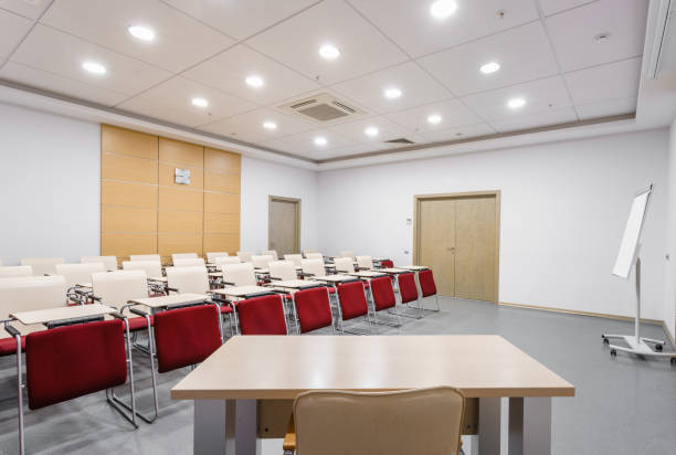istock Seminar presentation. Empty conference room, lots of empty seats. Auditorium for workshops and seminars. Red color. 971305298