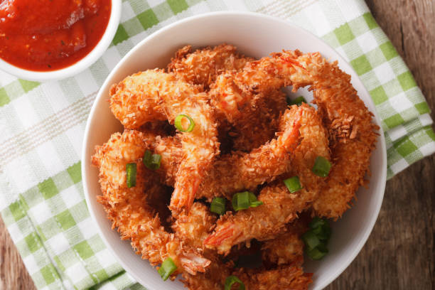 istock fried coconut shrimp closeup and tomato sauce. horizontal top view 971313494