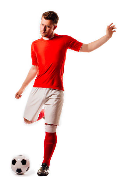 istock Young soccer player with ball on black background in studio 971331702