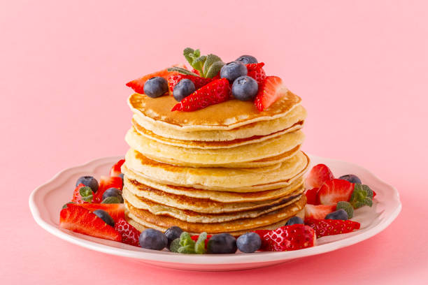istock Pancakes with berries on a bright pastel background 971332086