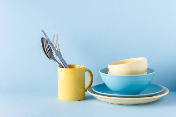 istock Crockery and cutlery on a blue pastel background 971332104